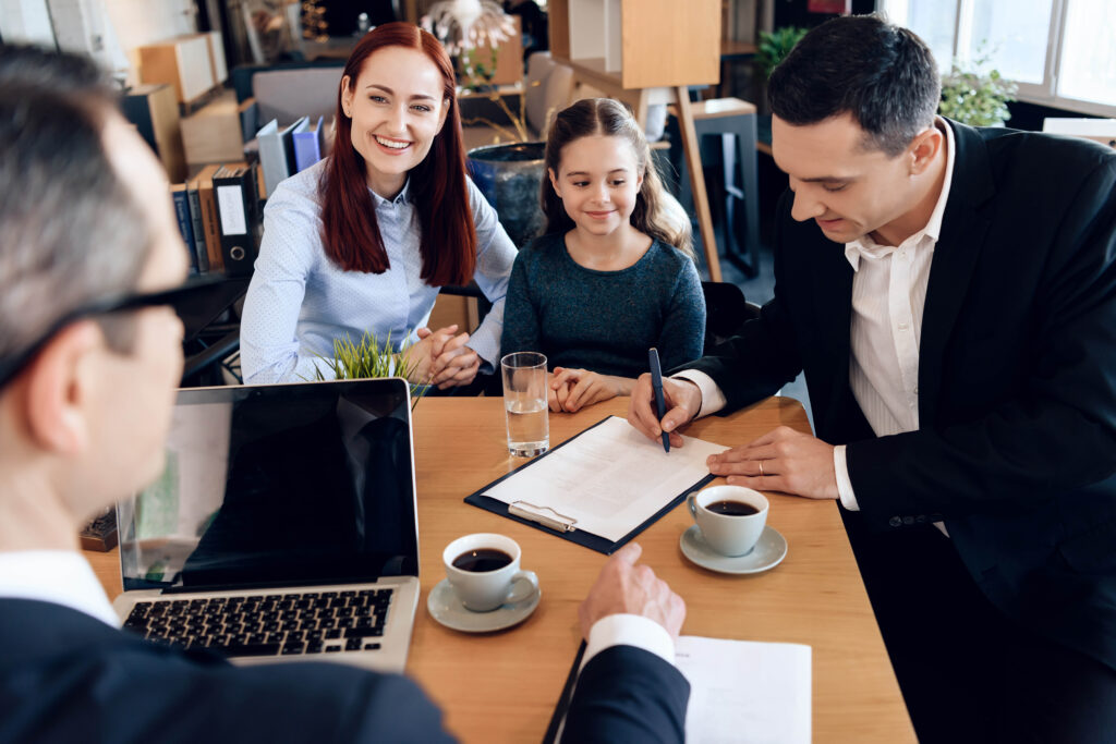 Feig Mediation Group - Mediation Podcast Image showing parents signing documents at mediator's office with happy child in the middle