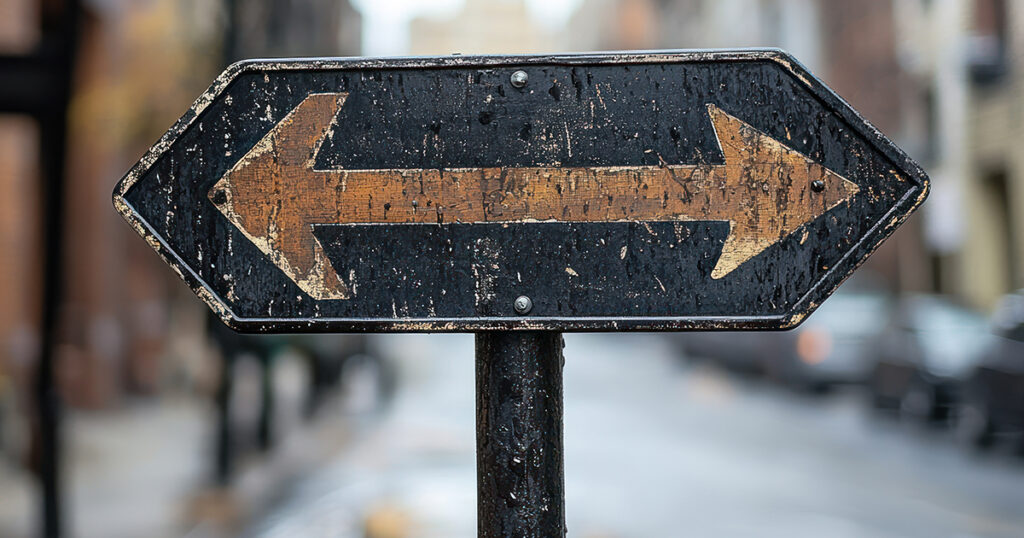 Street sign with arrows pointing in two directions indicating choice